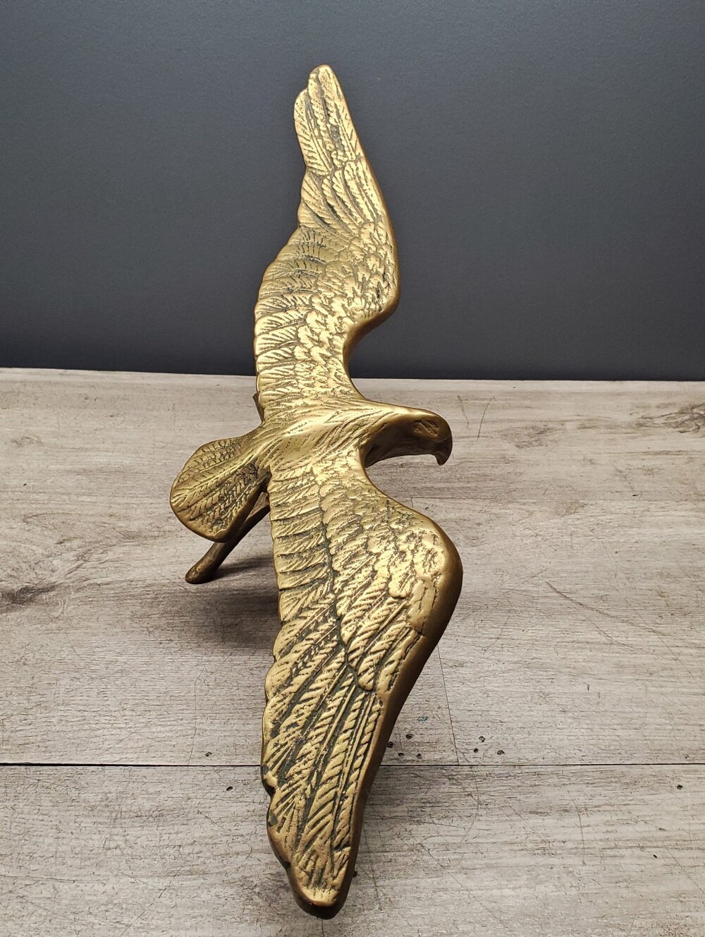 Vintage solid brass eagle figurine perched on a branch